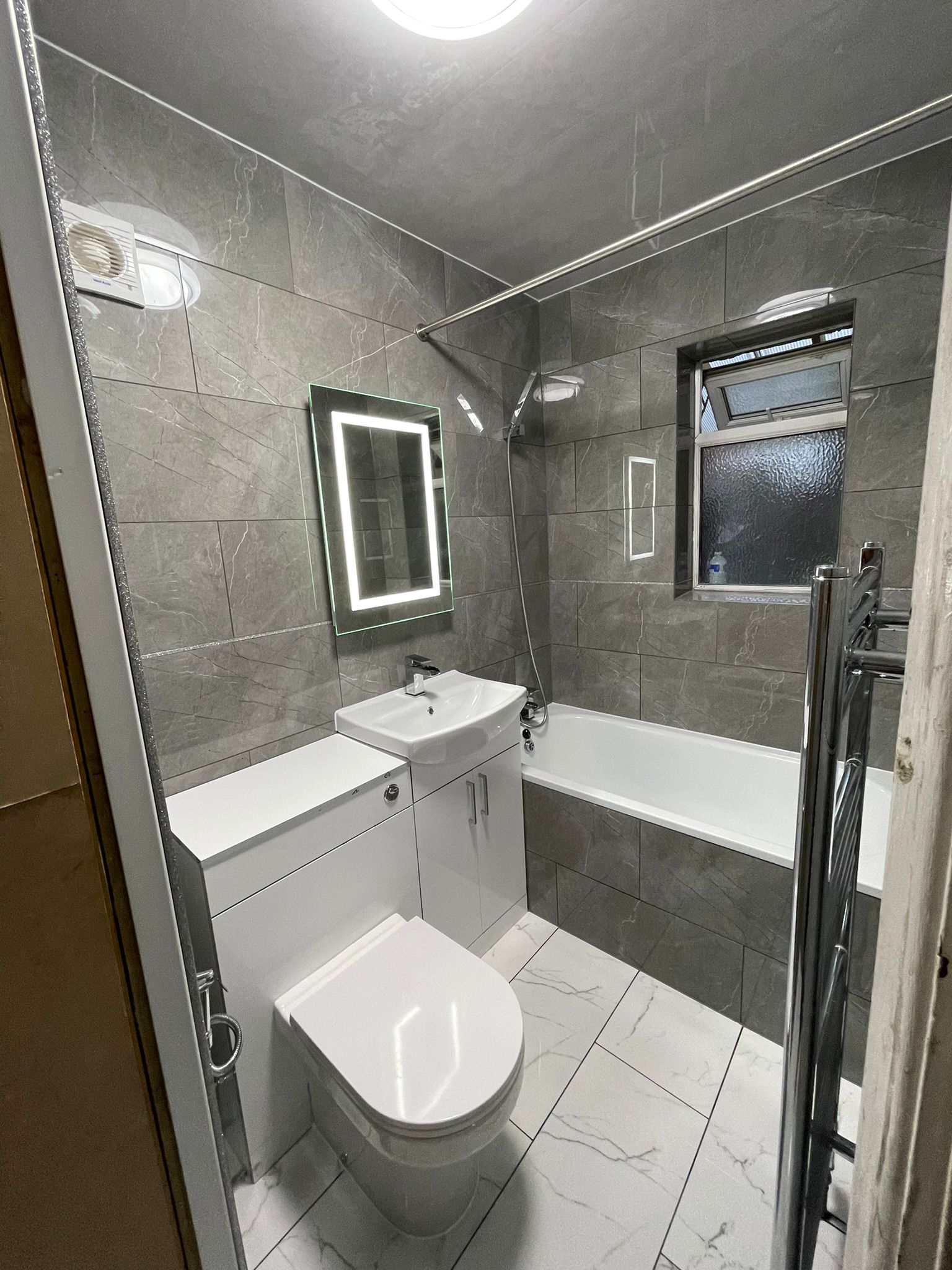 Grey marble bathroom with LED mirror