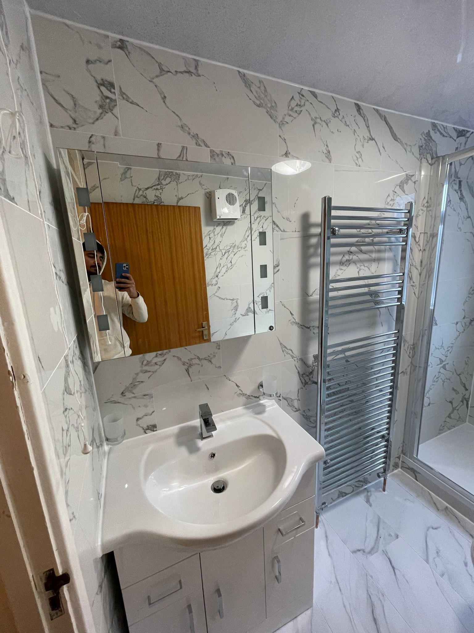 Marble bathroom with glass shower enclosure